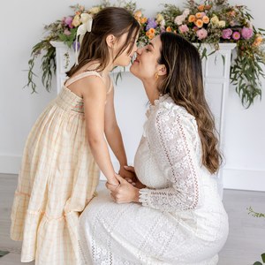 Mother and daughter sharing a quiet moment in a floral studio