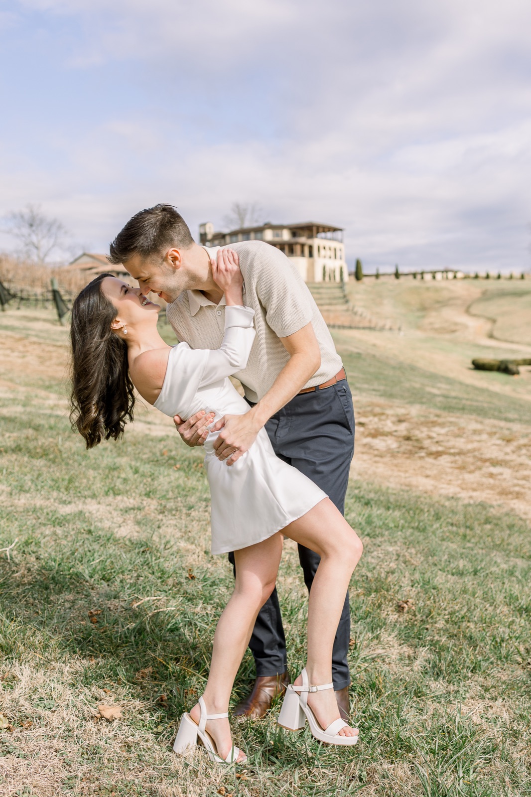 Engaged couple laughing together outdoors