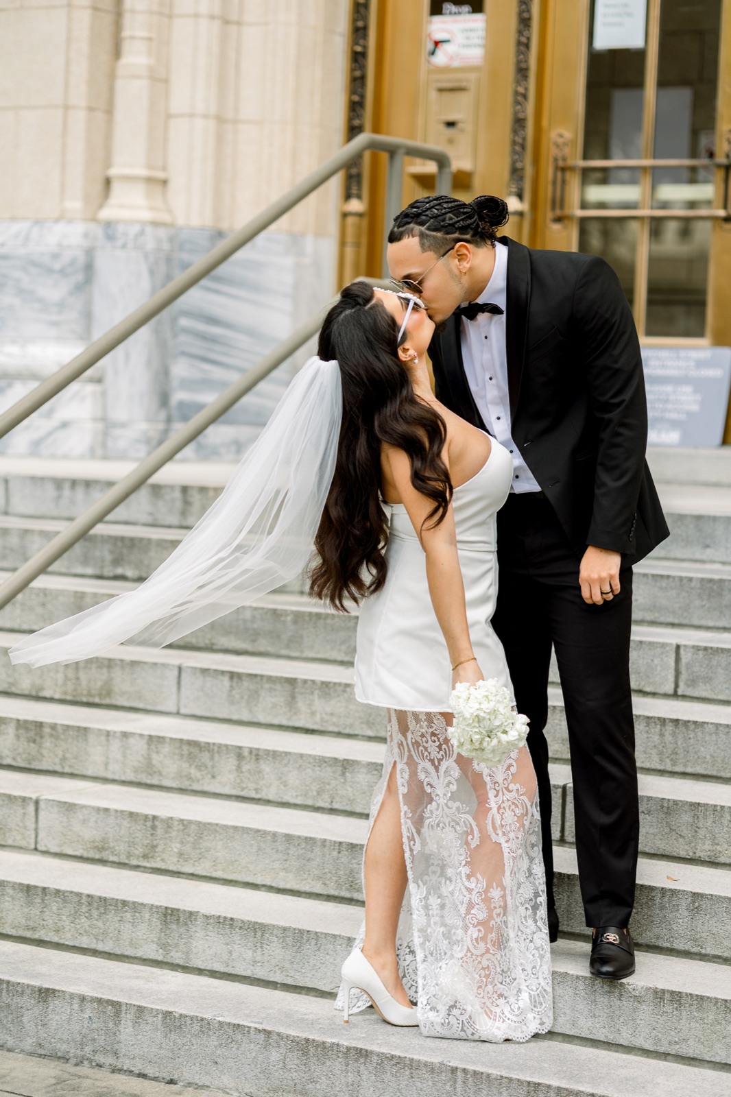 Couple kissing on the city hall steps