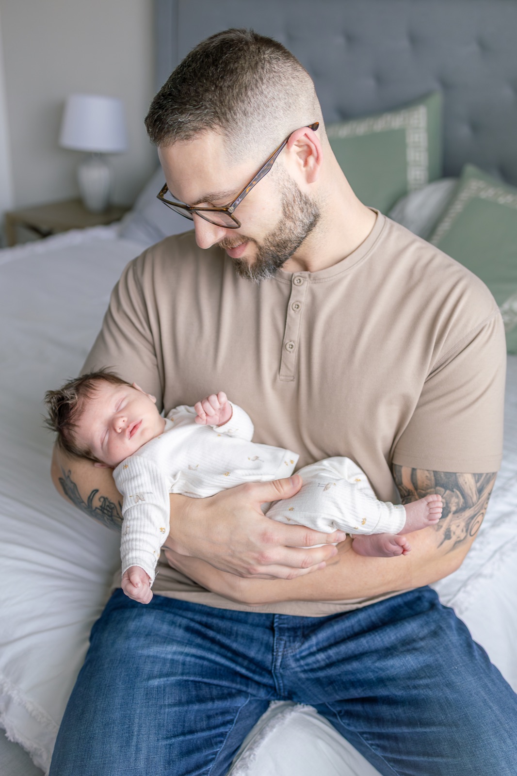 Newborn sleeping in his father's arms