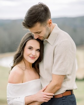 Laura and Tyler embracing outdoors in North Georgia