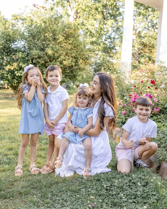 Mother with her four children in a spring garden