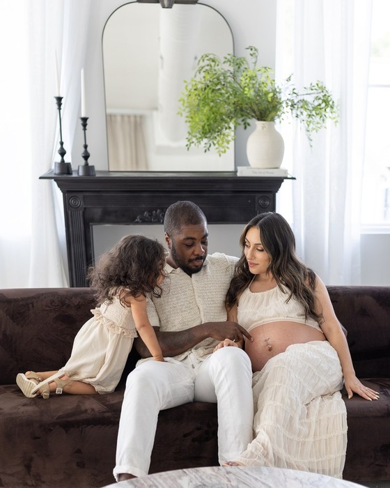 Expectant parents with their daughter during a studio maternity session