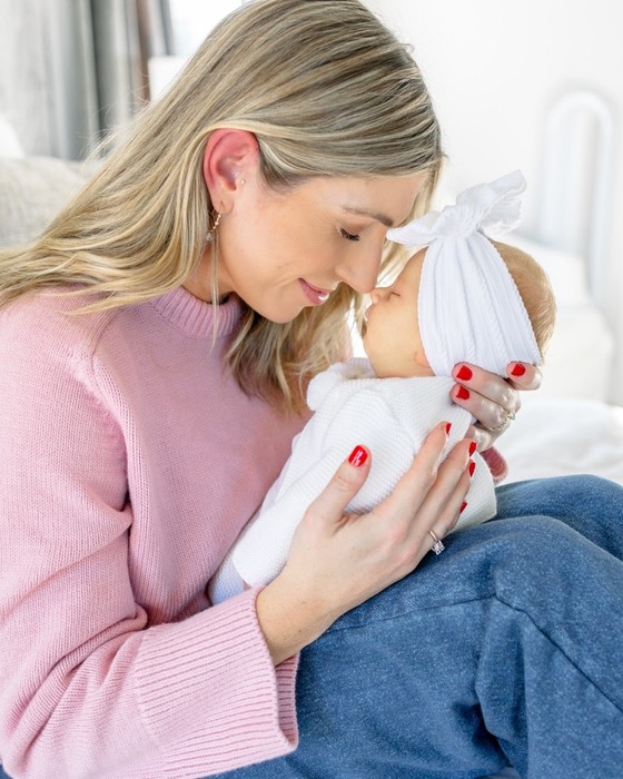 Mother holding her newborn close during a lifestyle session